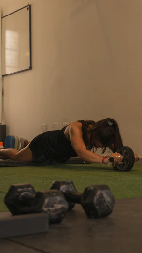 a person lying on a mat with weights on the side