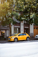 a yellow sports car parked on the side of a street
