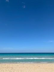 A serene beach scene with models in swimwear.