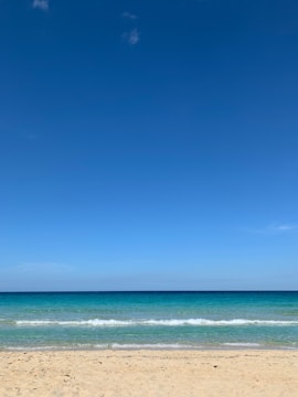 A serene beach scene with models in swimwear.