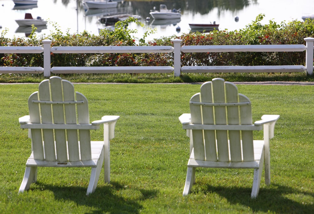 two white chairs on grass