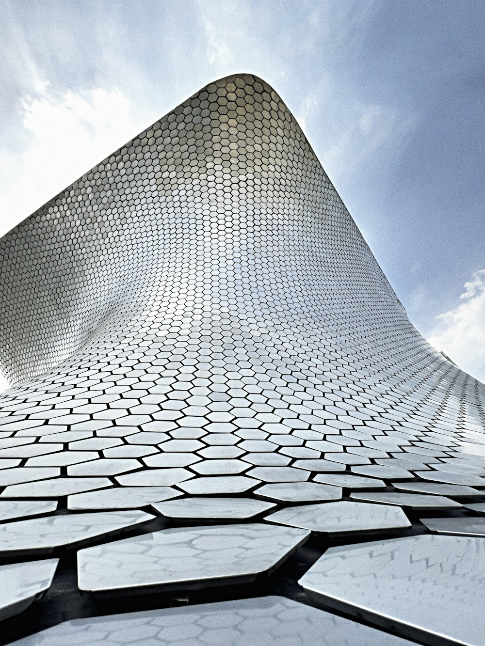 a tall building with many windows with Museo Soumaya in the background