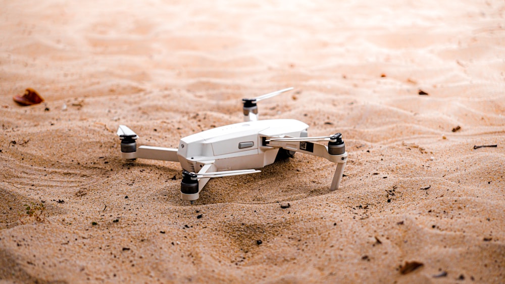 a drone flying over sand