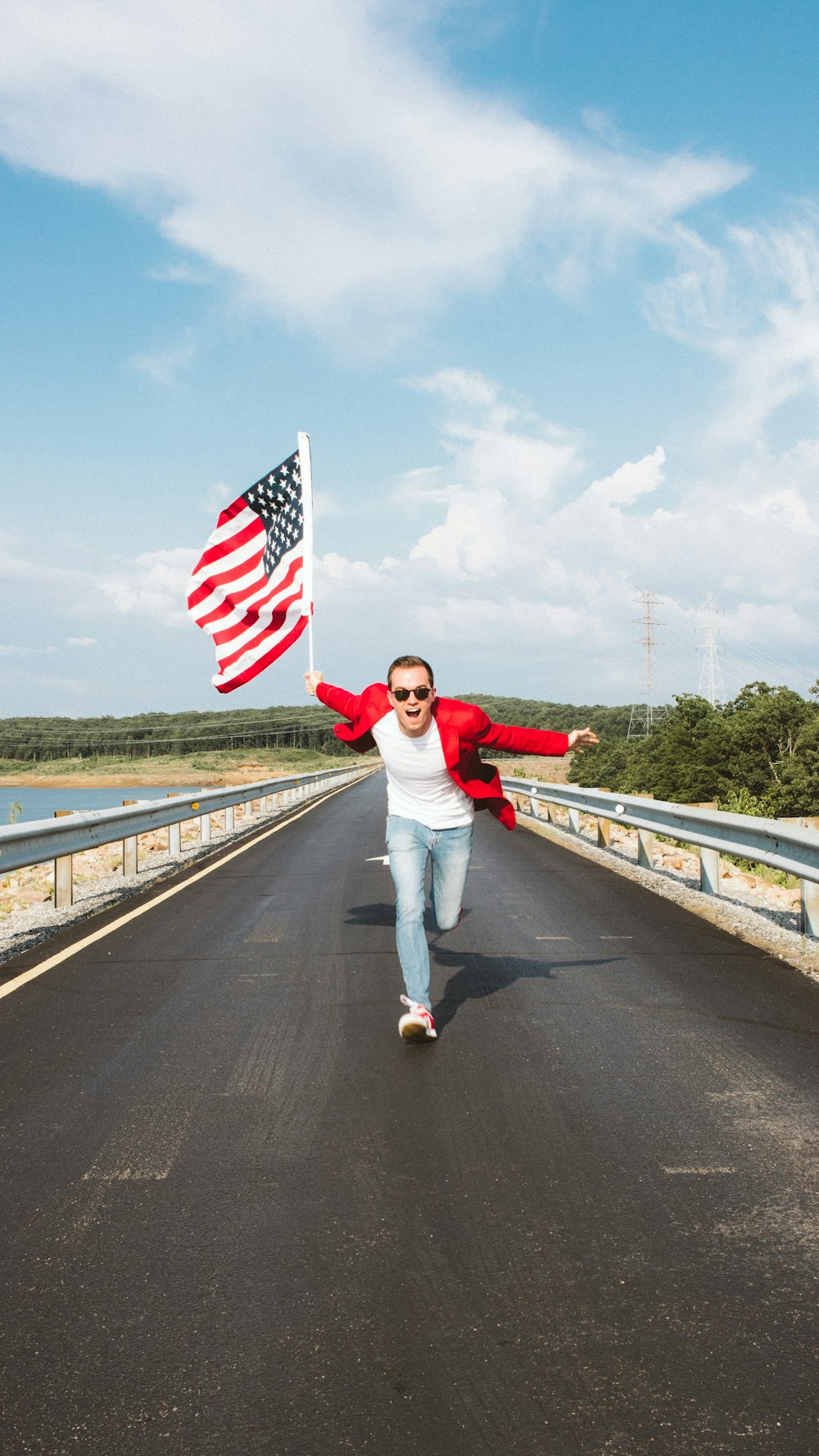 a person holding a flag on a bridge