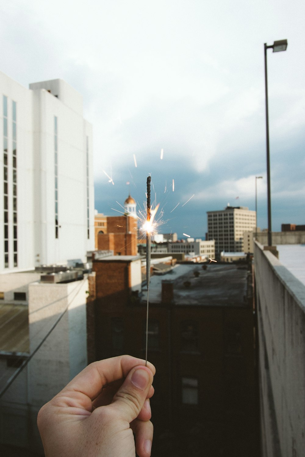 a hand holding a finger up in front of a city