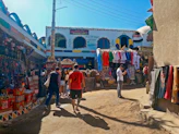 A traveler joyfully exploring a vibrant local market in a colorful, authentic destination.