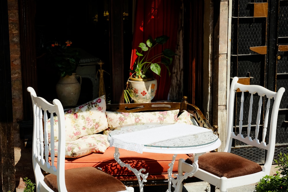 a table with a pillow and potted plants on it