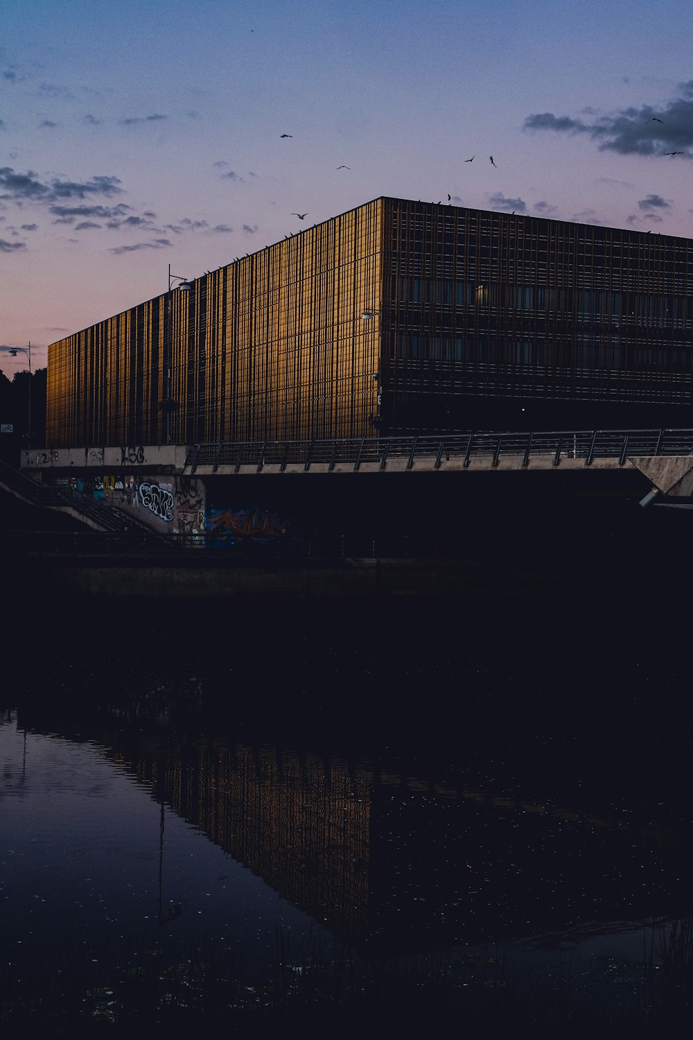 a building with a bridge and water