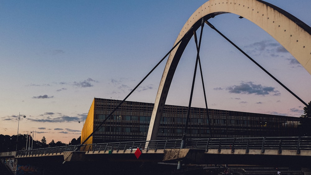 a large bridge with a building in the background