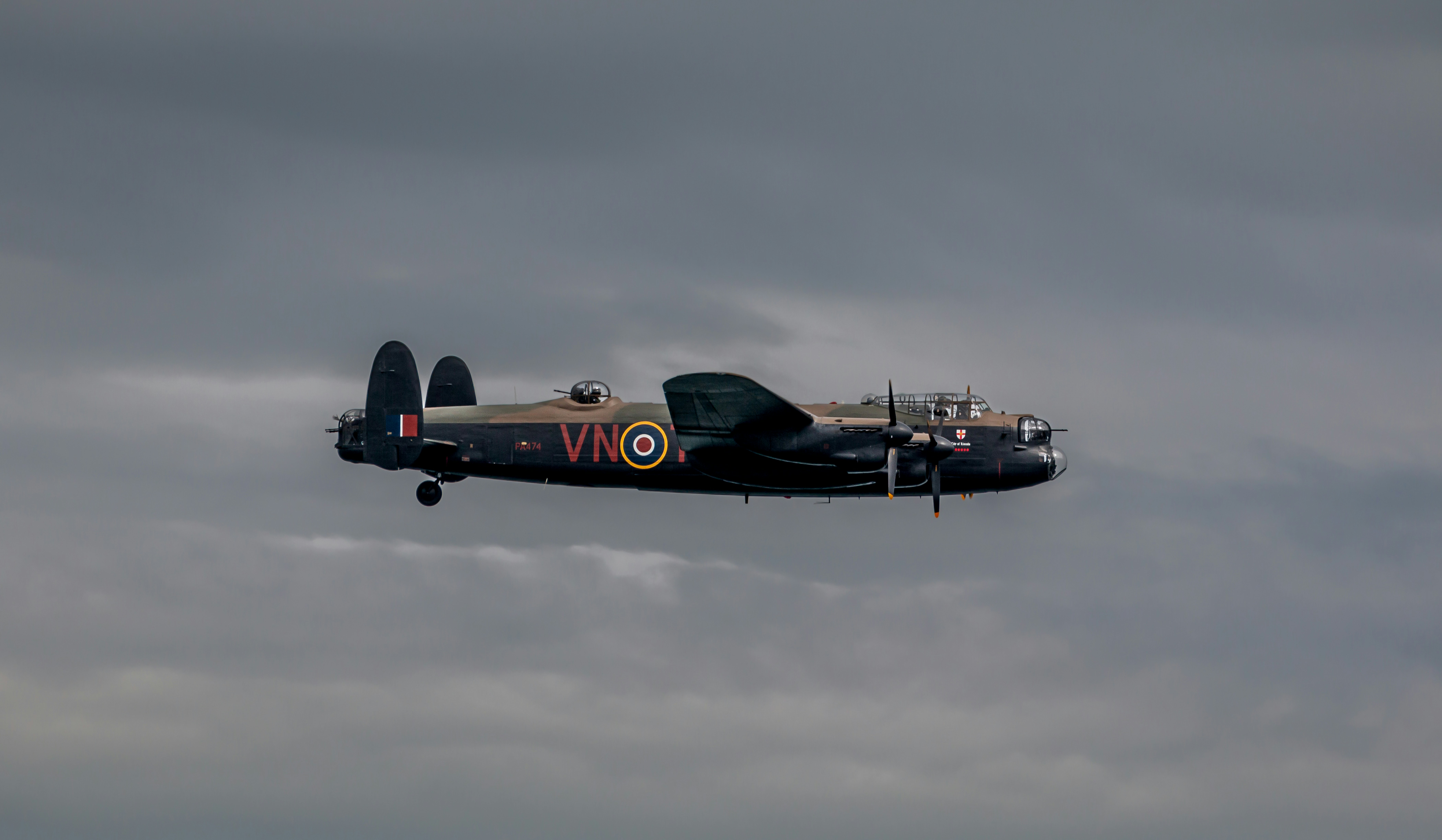 a plane flying in the sky, A Lancaster Bomber at Teignmouth Airshow 2022, Devon