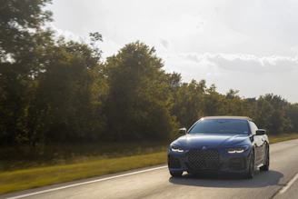 Sleek summer tires on a shiny car driving on a sunny highway