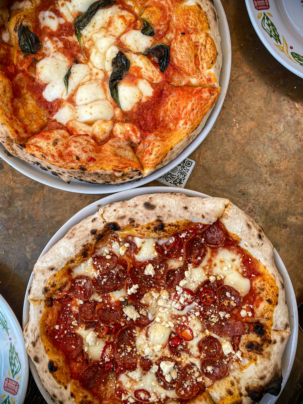 a couple of pizzas on plates