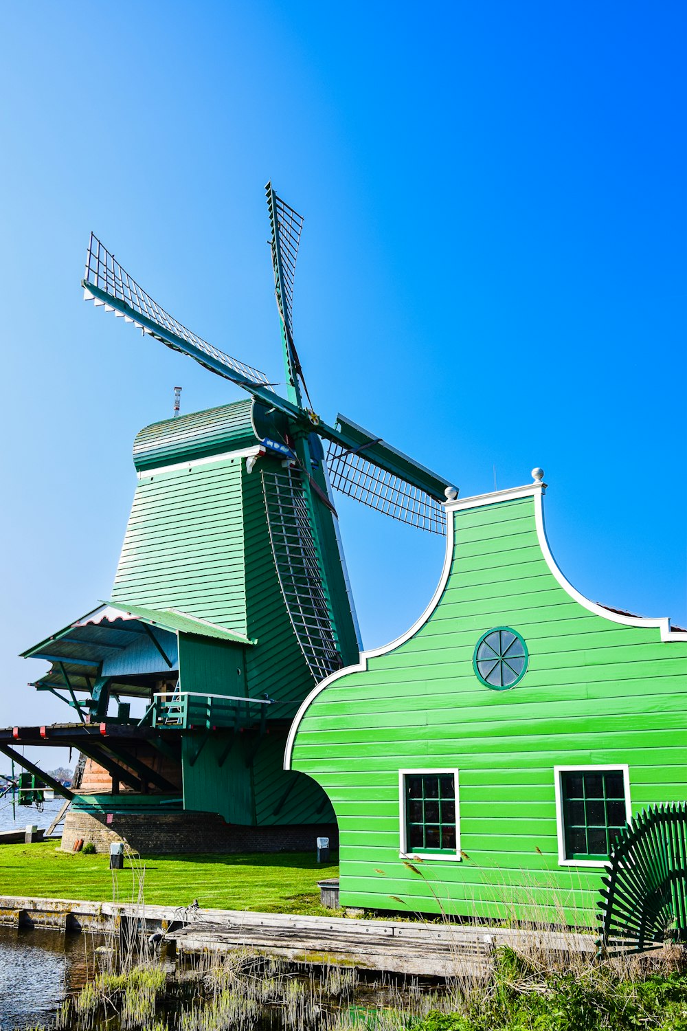 a green building with a windmill