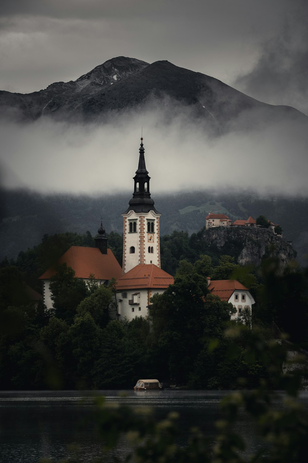 a building with a tower and a mountain in the background