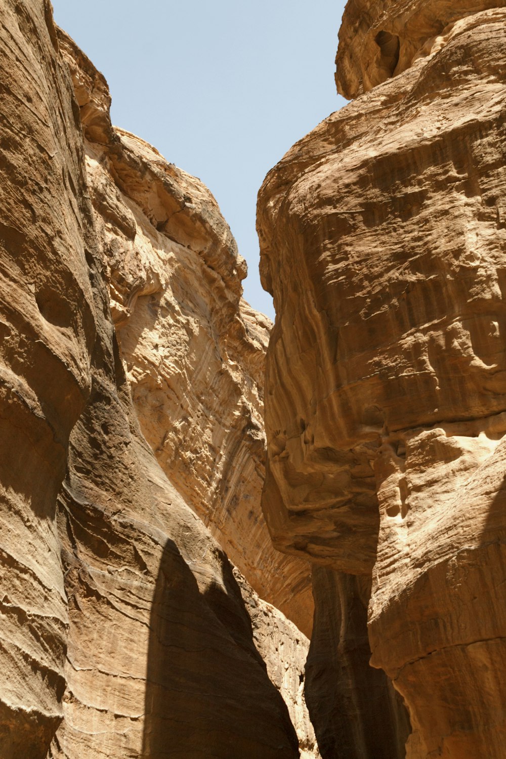 a large canyon with a blue sky