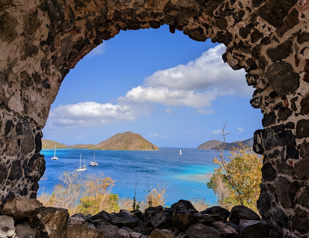 a view of a bay through a stone archway
