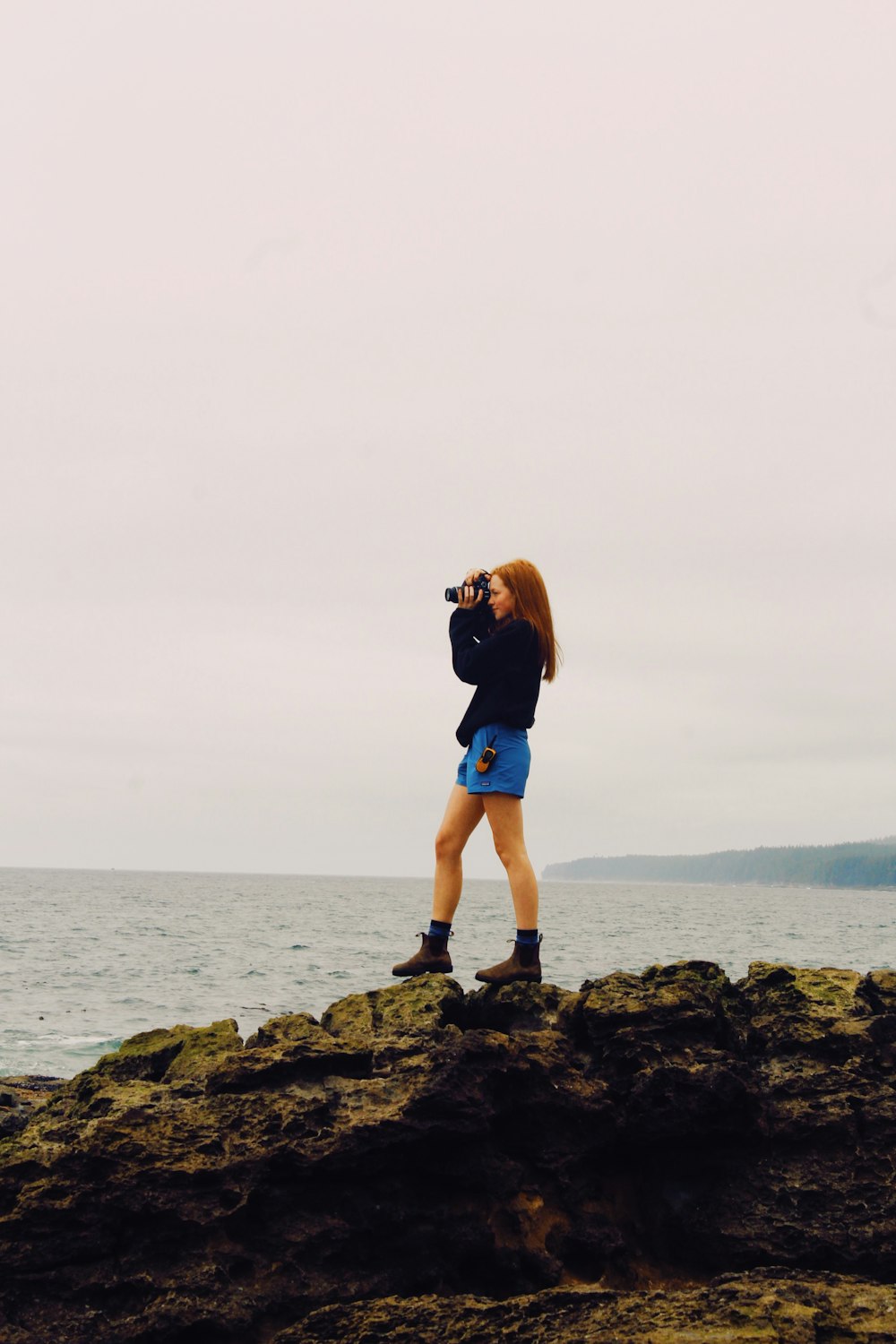 a man taking a picture of the water