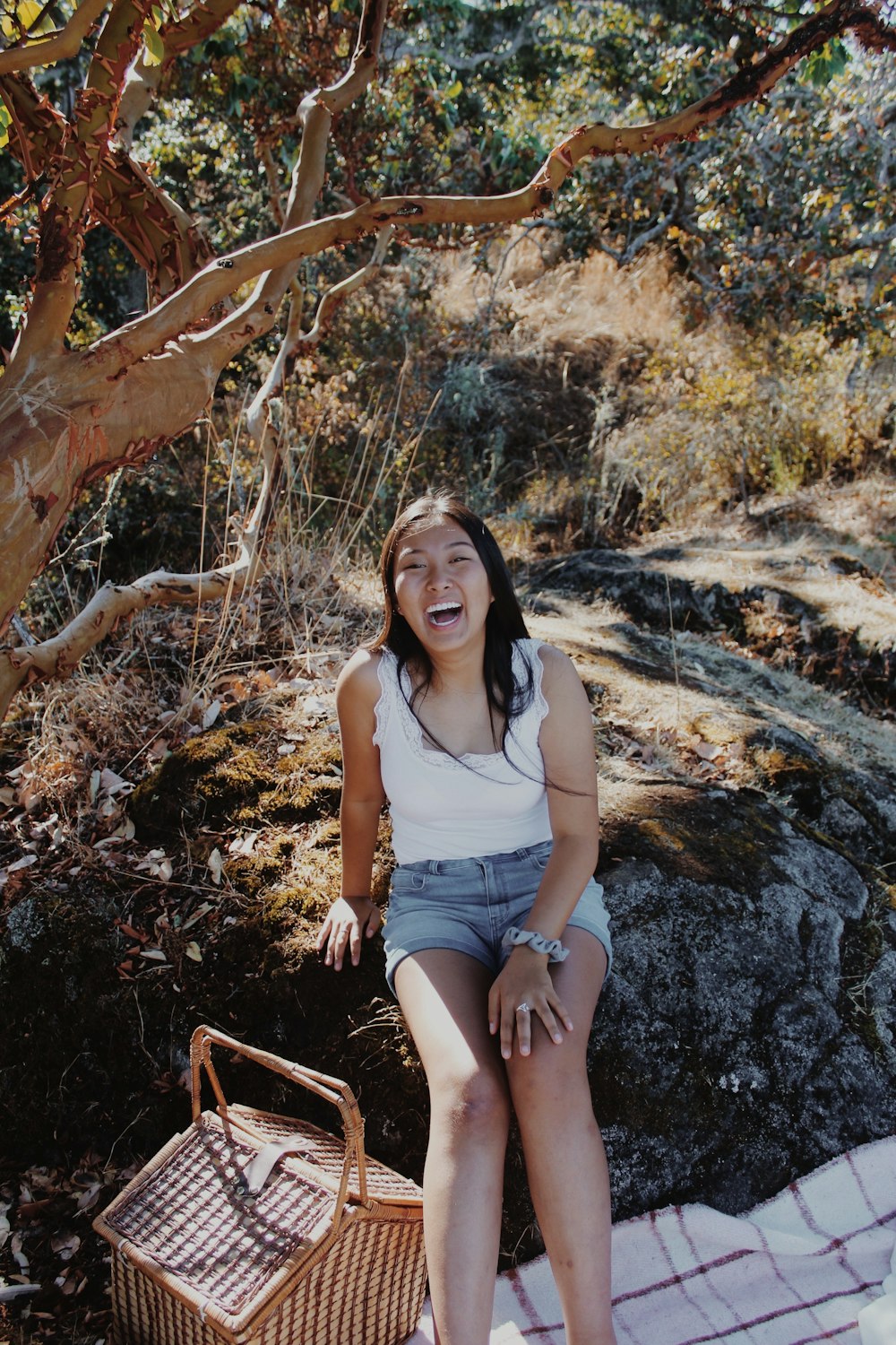 a woman sitting on a rock