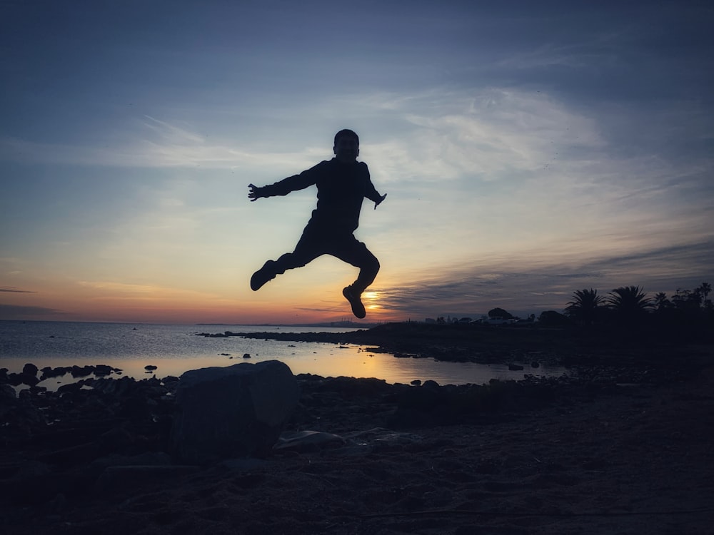 a man jumping over rocks