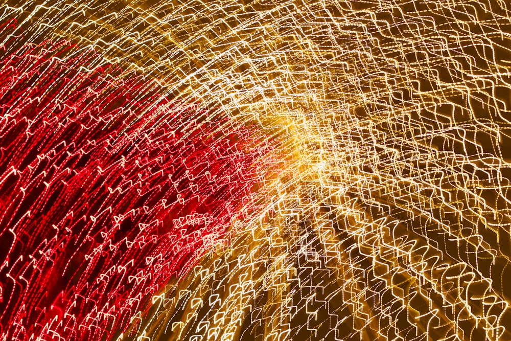 a close up of a red and yellow feather