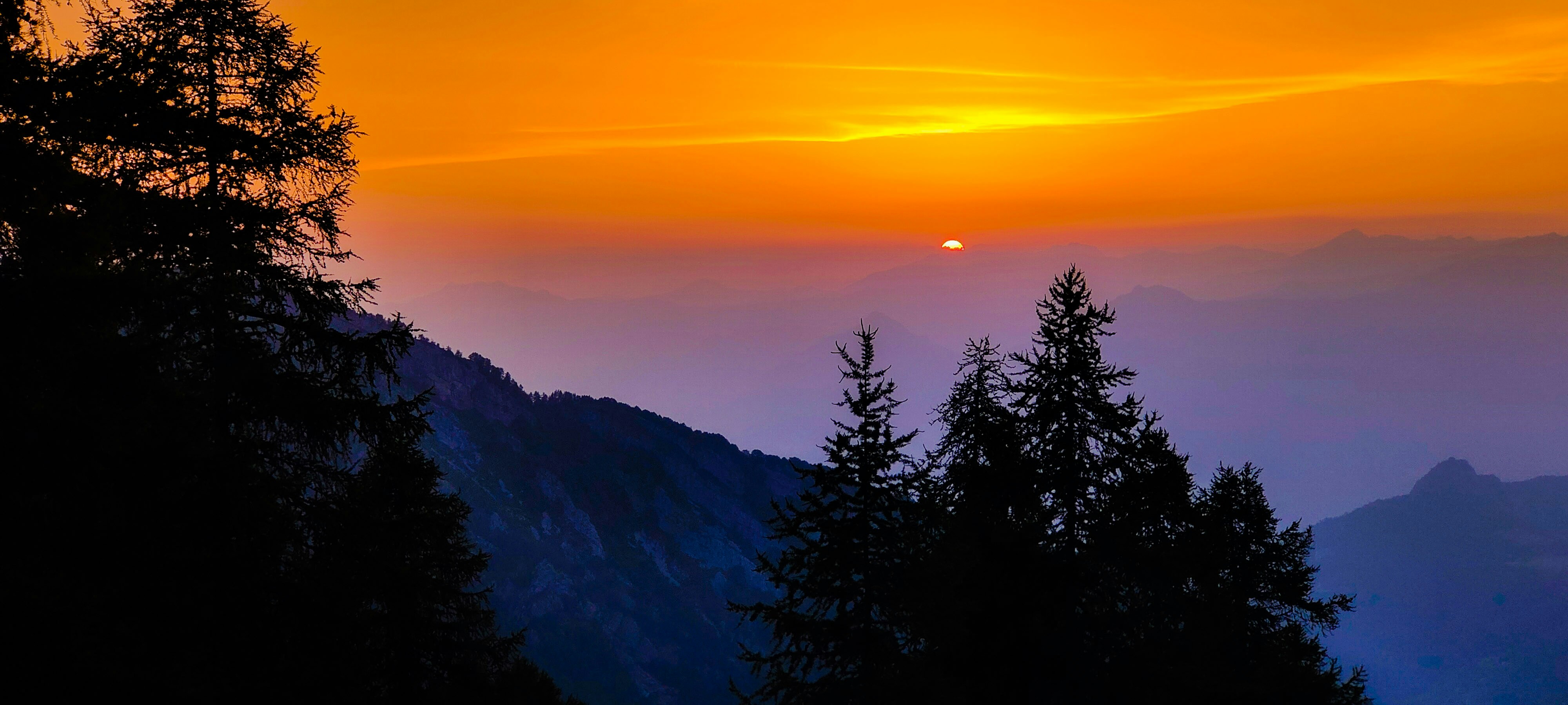 a sunset over a mountain range