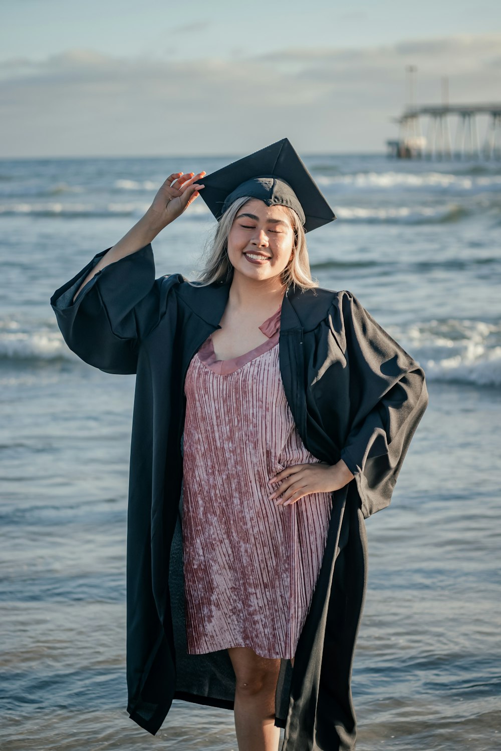 a person wearing a graduation gown and holding a diploma