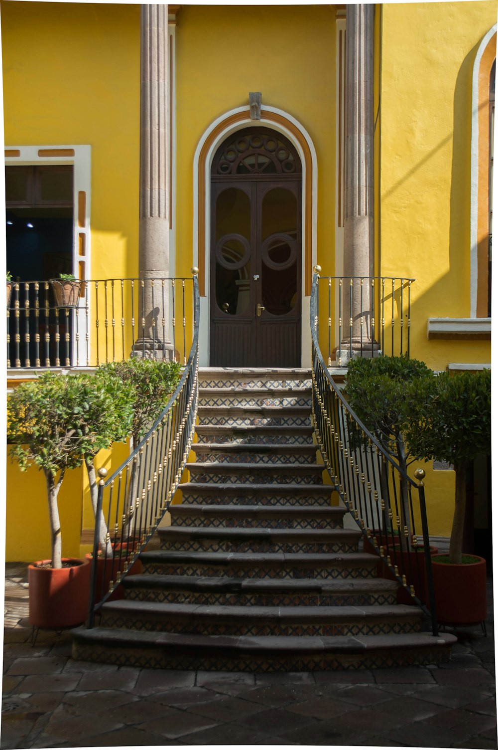 a yellow building with a staircase