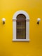 a window in a yellow building