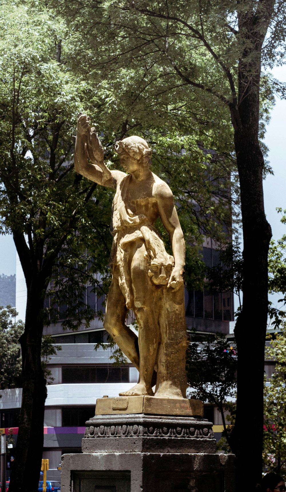 a statue of a person holding a book