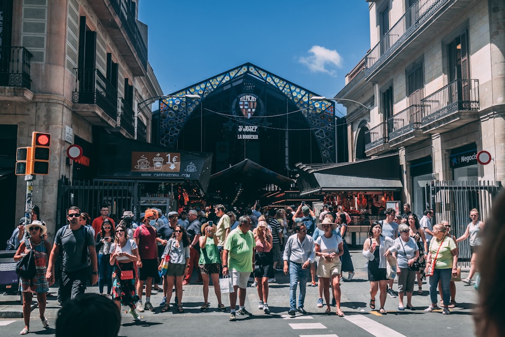 a crowd of people walking down a street