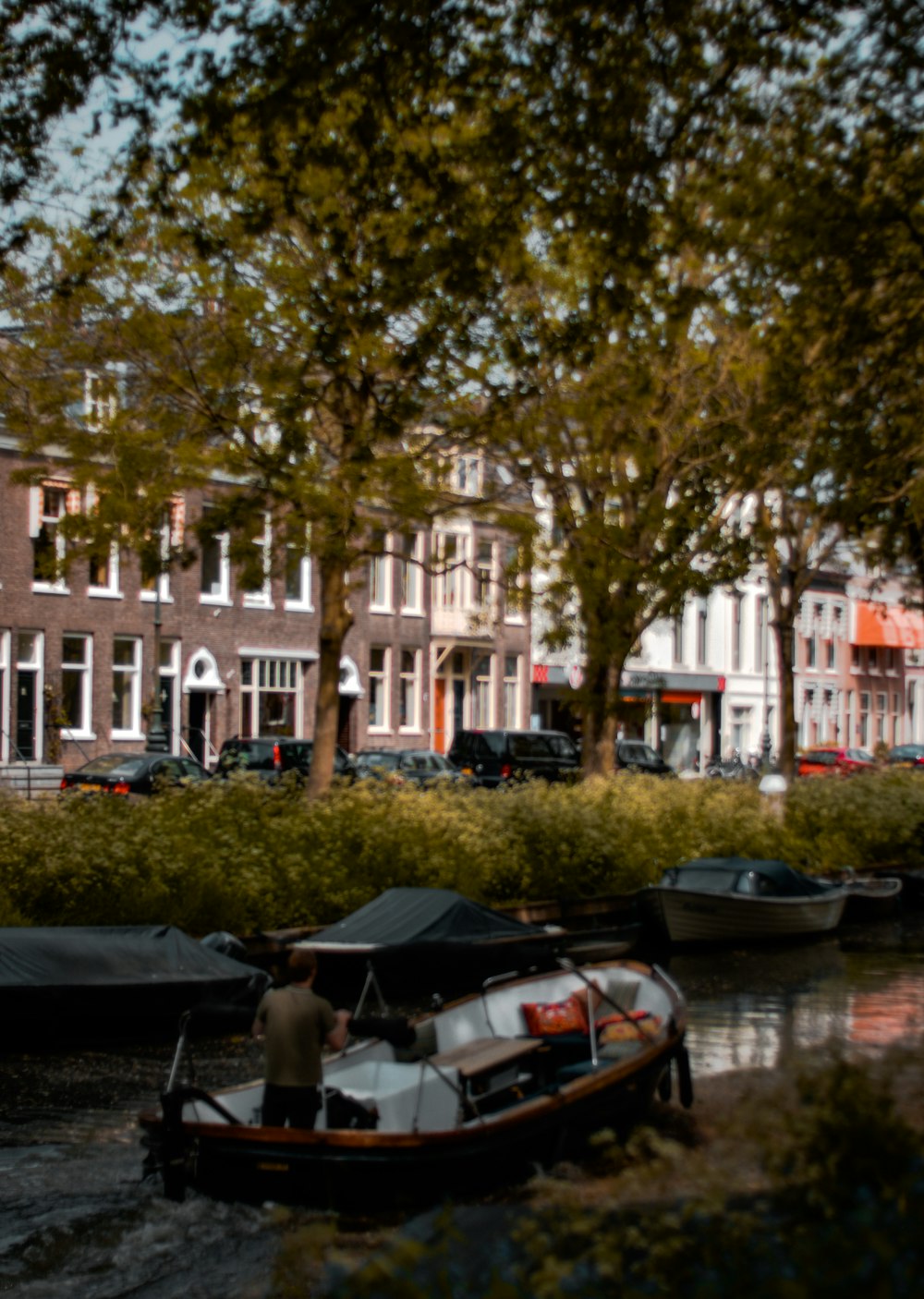 a person on a boat in a canal