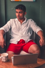 Jamie, a focused man in his office chair, typing thoughtfully on his laptop.