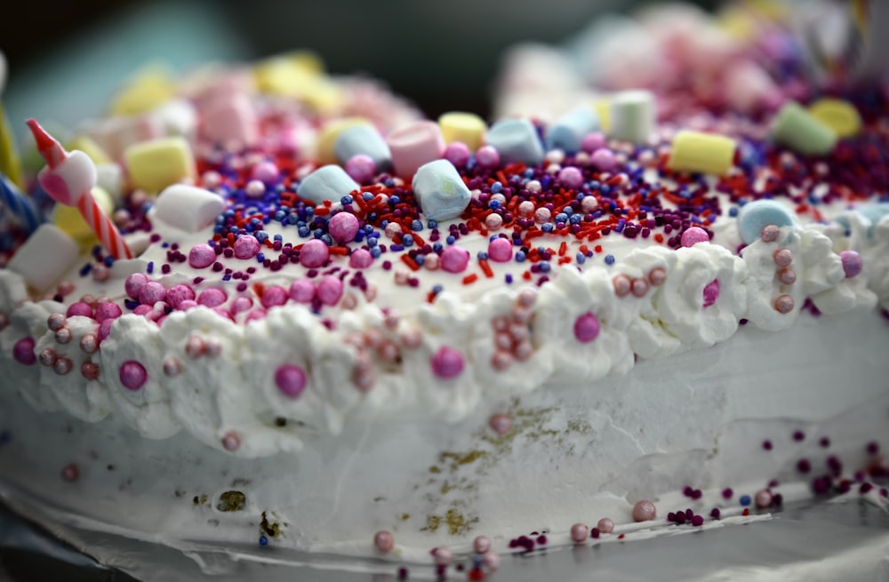 a cake with frosting and candy on top