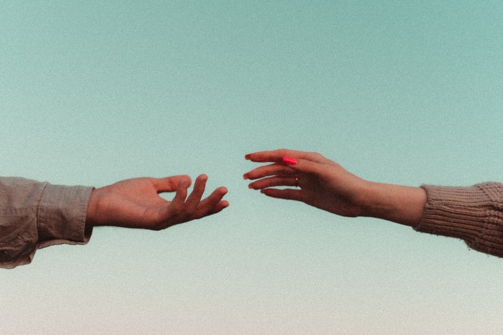 a close-up of hands shaking