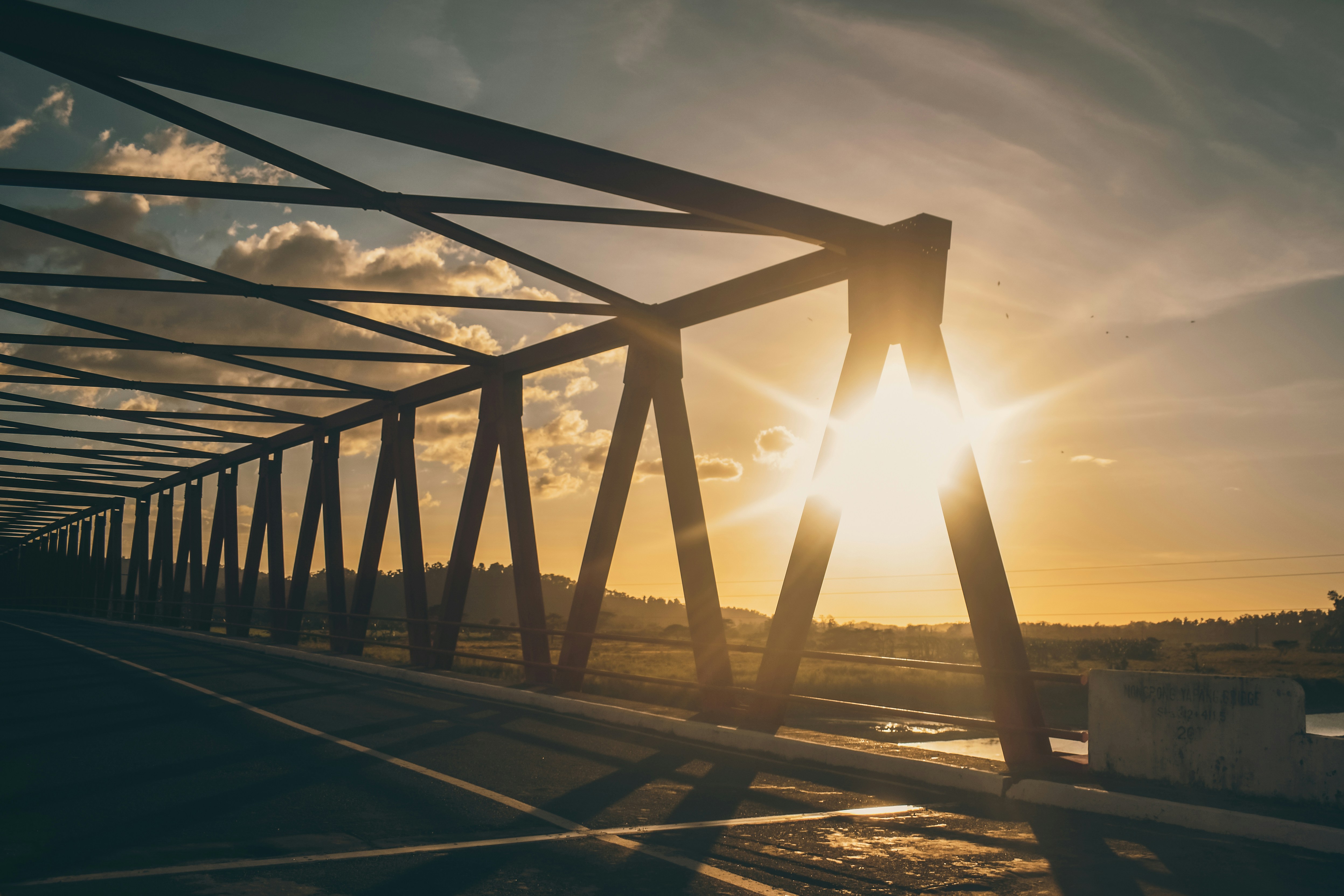 a large metal structure with a sunset