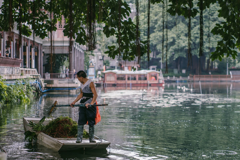 a man standing on a boat in a river