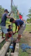 A plumbing trainee fixing pipes under the guidance of a mentor.