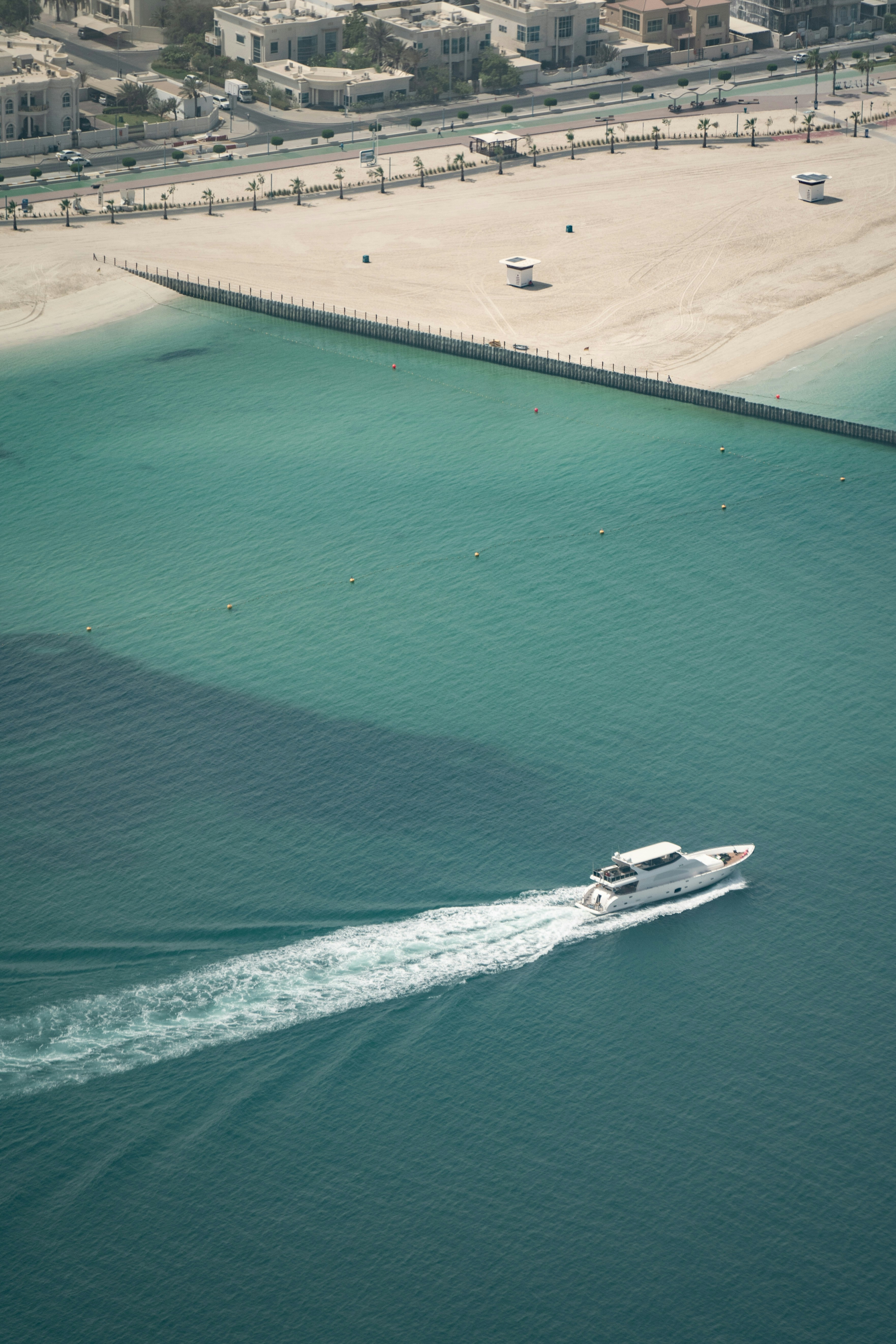 a beach with boats and a pier