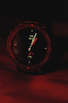Stylish gaming watch with red accents glowing against a dark background
