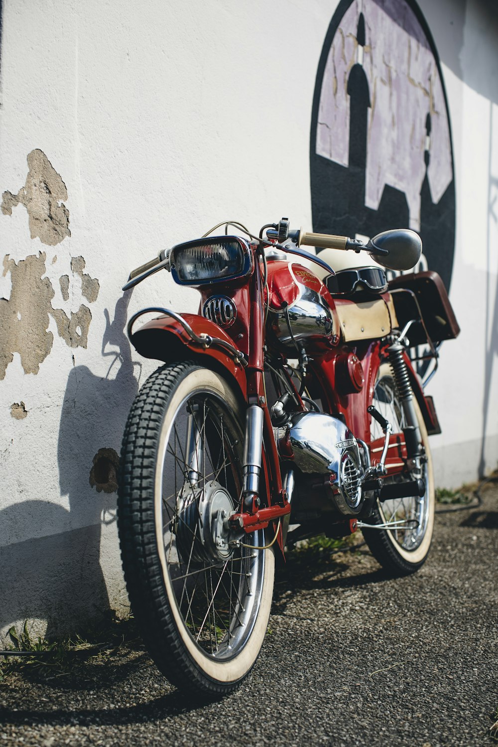 a motorcycle parked next to a wall