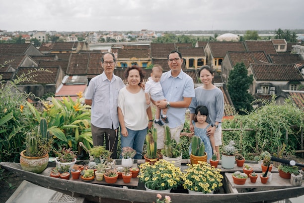 Happy family standing safely behind the newly installed balcony safety net by Arjilli Enterprises.