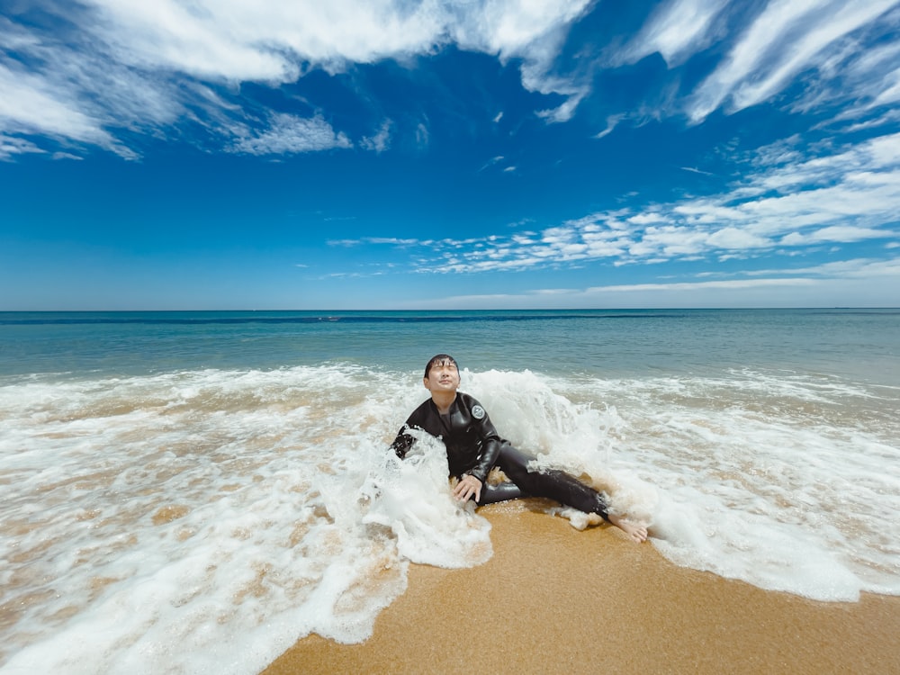 a man sitting on a beach