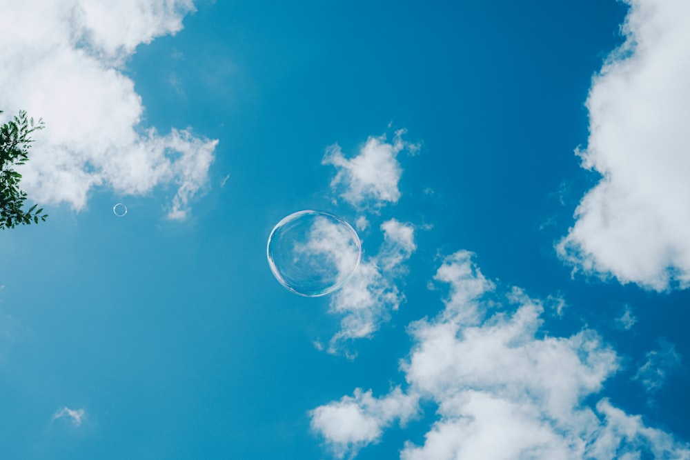 a blue sky with clouds and the moon