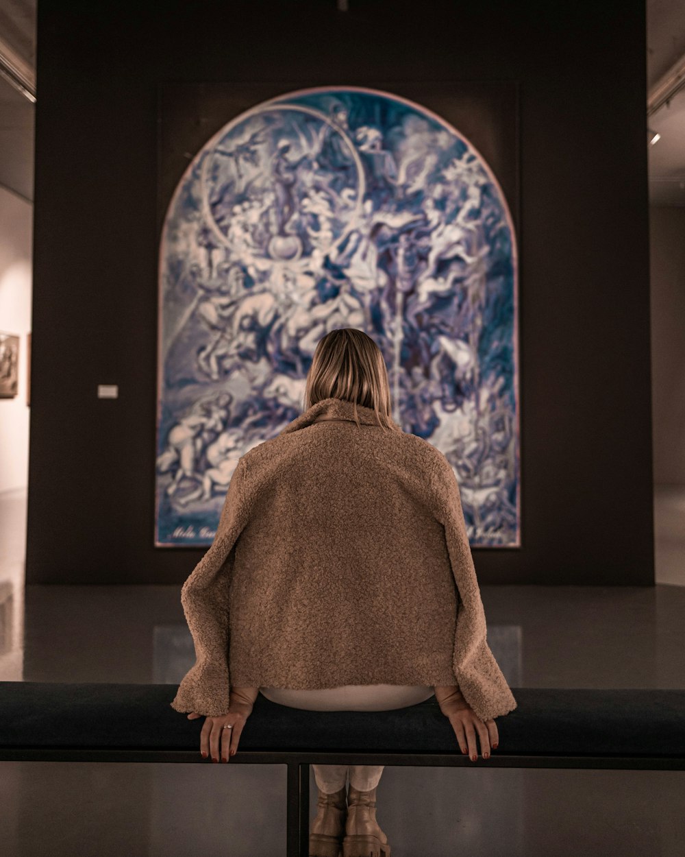 a person looking at a large painting