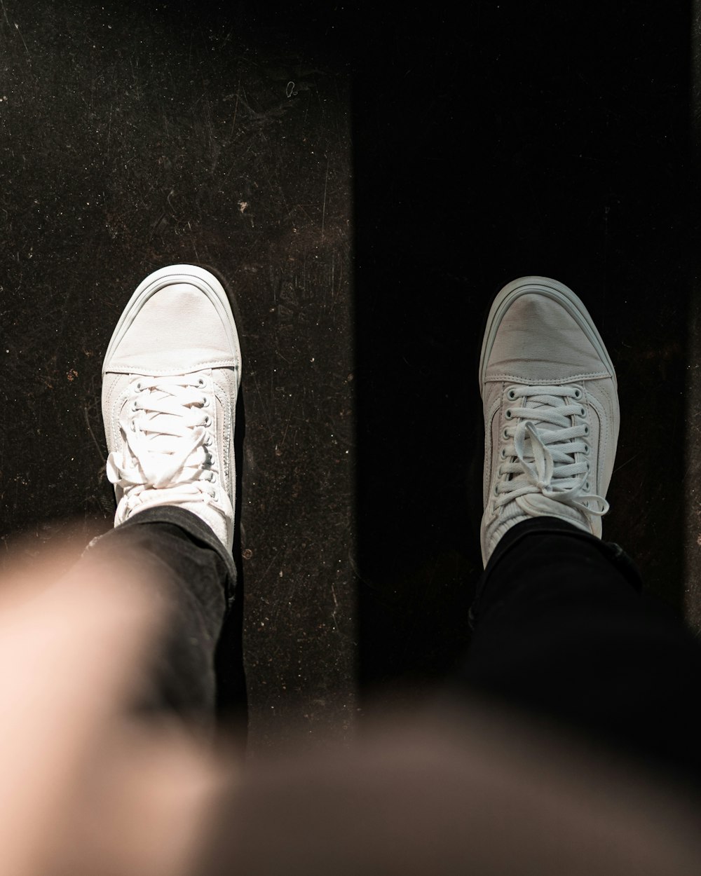 a pair of feet in white shoes