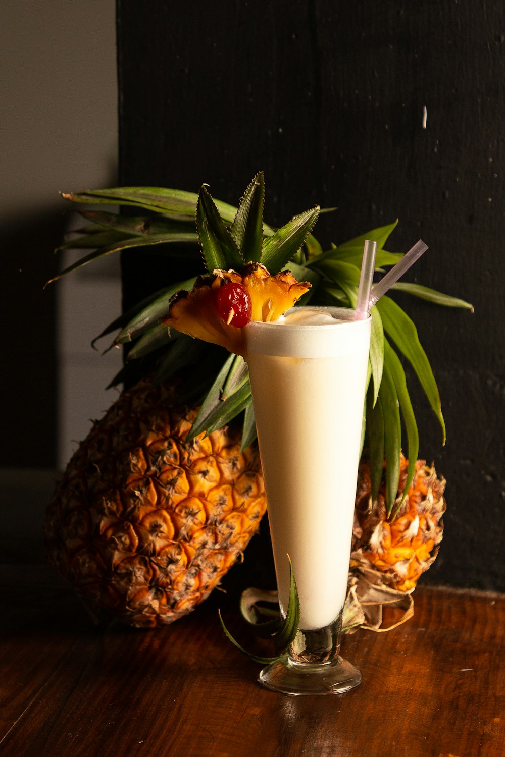 a glass with a drink and fruit in it