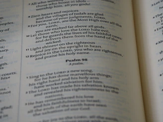 A close-up of a soft cotton shirt with a bold, uplifting Bible verse printed in elegant typography.