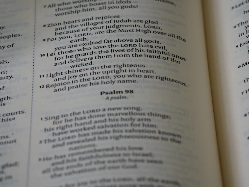 A close-up of a soft cotton shirt with a bold, uplifting Bible verse printed in elegant typography.