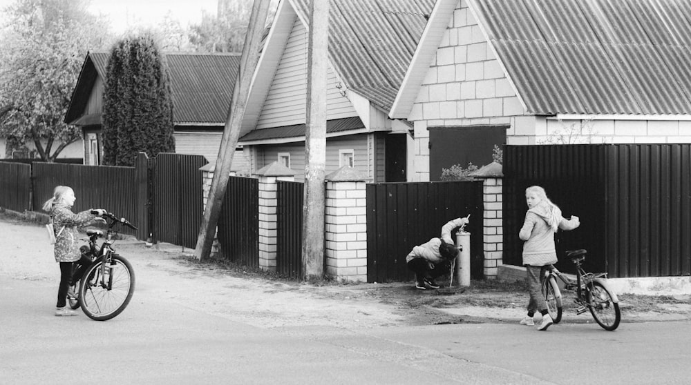 a couple of people stand near each other on bicycles