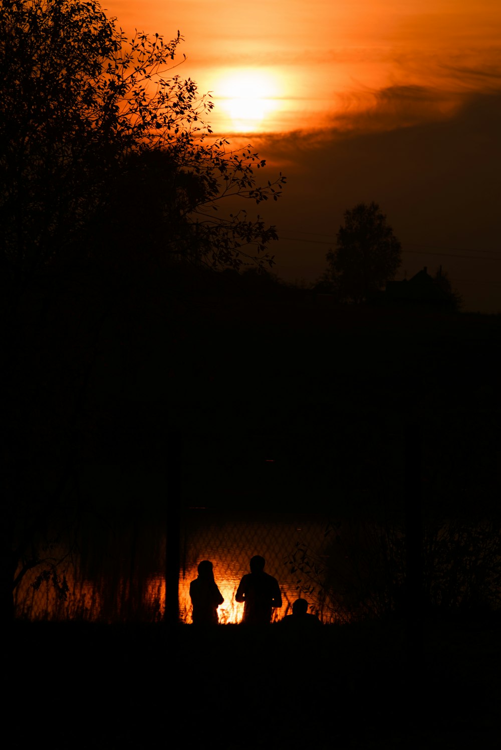 silhouette of a couple of people at night